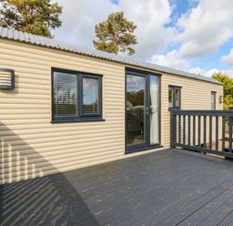 A cabin exterior with a deck at Masons Hut in West Mains near Haggerston