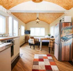 A kitchen with a table and chairs at Masons Hut near Haggerston