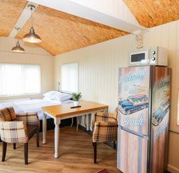 A studio with a bed and table at Masons Hut West Mains near Haggerston