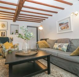 A living room with a sofa, armchair and coffee table at Elm Cottage in Moreton-In-Marsh