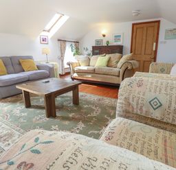 A living room with sofas and a coffee table at The Cottage in St. Ives