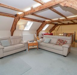 A living room with sofas and a table at Yr Hen Ysgoldy