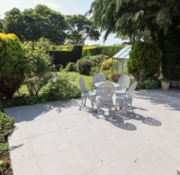 A garden with a table and chairs at Rose Cottage Dunstan near Embleton