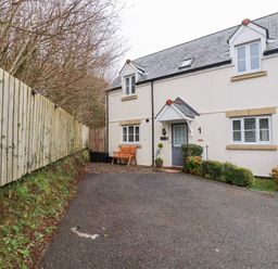 A house with a pathway and bench at Poldam in St Austell