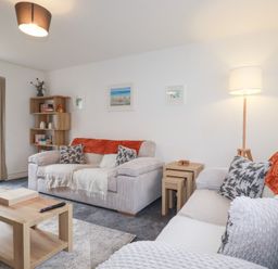 A living room with a sofa and coffee table at Poldam St Austell