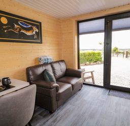 A snug with a sofa and coffee table at Alken The Hare in Bushmills