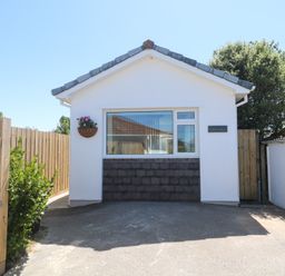 A house with a front entrance and wooden fence at Carn Brea in Redruth