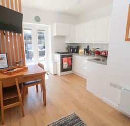 A kitchen with table and chairs at Carn Brea in Redruth