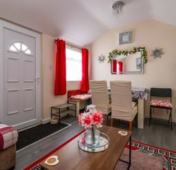 A living room with a dining area and front door at Sandbay in Bridlington