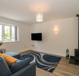 A living room with a sofa and television at 1 The Stables Highbridge