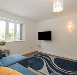 A living room with a sofa and television at 1 The Stables Highbridge