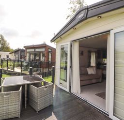 An outdoor area with a deck and seating at 22 Yealand in Carnforth