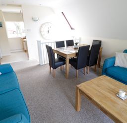 A dining room with a table and chairs at Valley Lodge 2 in Callington