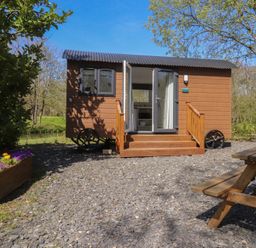 A tiny house with steps and outdoor seating at Butterfly Hut 2 Forton near Garstang