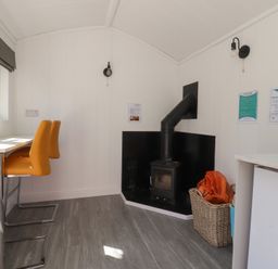 A kitchen with table and stools at Butterfly Hut 2 Forton near Garstang