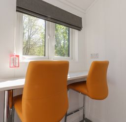 An office space with a table and two chairs at Butterfly Hut 2 Forton near Garstang