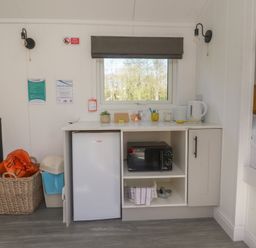 A kitchen area with fridge and microwave at Butterfly Hut 2 Forton near Garstang
