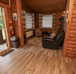 A living room with a sofa and chairs at Farnes Lodge in Longframlington