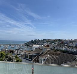 A view of a harbor with boats and houses at 21 Station Hill