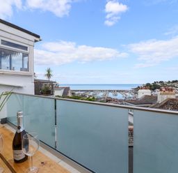A balcony with a view of the sea and marina at Still Waters in Brixham