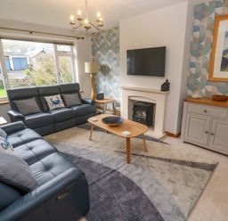 A living room with a sofa and a coffee table at Byron's Retreat in Crantock
