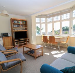 A living room with a sofa coffee table and television at Purbeck Vista in Swanage