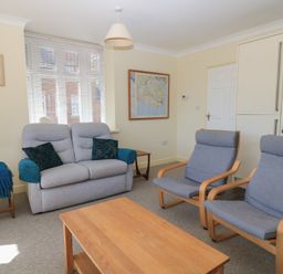 A living room with a sofa and two armchairs at Purbeck Vista in Swanage
