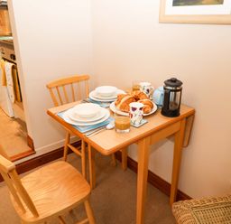 A kitchen table with a breakfast setup at Hayloft in Ipswich