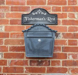 A mailbox and nameplate on a brick wall at Fisherman's Rest in Ipswich