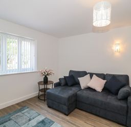 A living room with a sofa and window at 3 The Stables in Highbridge
