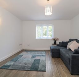 A living room with a sofa and rug at 3 The Stables in Highbridge