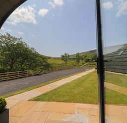 An outdoor view showing a paved pathway and grass at Barley near Nelson