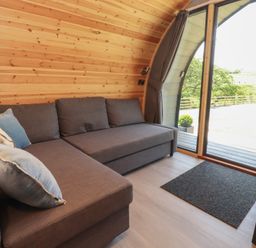 A snug with a couch and large window at Barley near Nelson