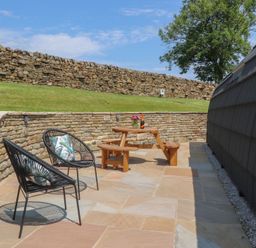 An outdoor area with a table and chairs at Black Moss in Nelson