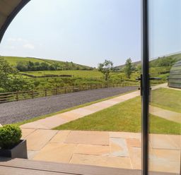 A view from an open door of a garden pathway at Black Moss in Nelson