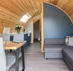 A living room with a table and chairs at Black Moss in Nelson