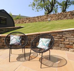 Two chairs with cushions in a garden area at Ogden in Nelson