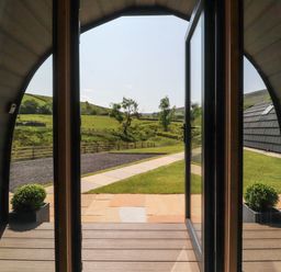 An outdoor view from a pod looking at the pathway and landscape at Ogden in Nelson