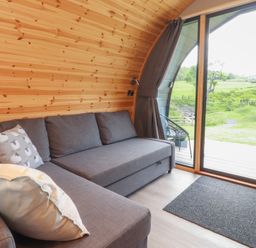 A living room with a sofa and view of the outdoors at Pendle in Nelson