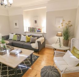A living room with a sofa and coffee table at Bwthyn Morse in Llanfair
