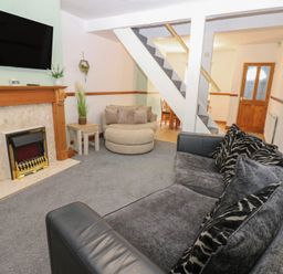 A living room with a fireplace and television at Bolton Terrace in Workington