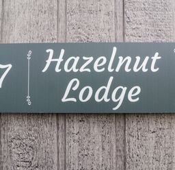 A house sign displaying the number 7 and Hazelnut Lodge at Hazelnut Lodge in Chipping Norton