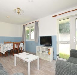 A living room with a table and chairs at 4 Rosecraddoc Lodge Holiday Bungalows Liskeard