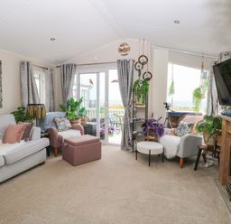 A living room with a sofa and television at No. 2 - Seaview in Kessingland