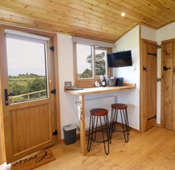 A snug with a bar and two stools at Defaid Cymreig in Oswestry