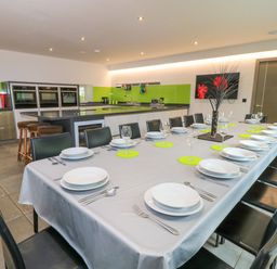 A dining room featuring a long table set for a meal at Silver Copse Frilford Heath Near Abingdon