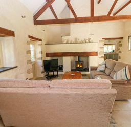 A living room with a sofa and television at Carreg Las, Haverfordwest