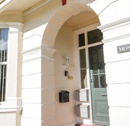 An entrance with a door and mailbox at Flat 1A, Mona House in Conwy