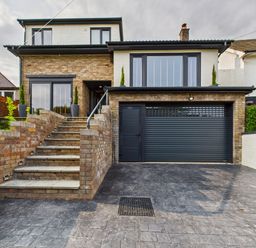 A house with a garage and stairs at 59a Gwscwm Road