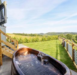 An outdoor area with a hot tub and grass at Charollais in Oswestry